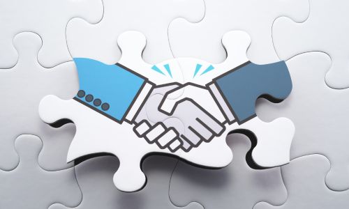 Image of puzzle with a business handshake