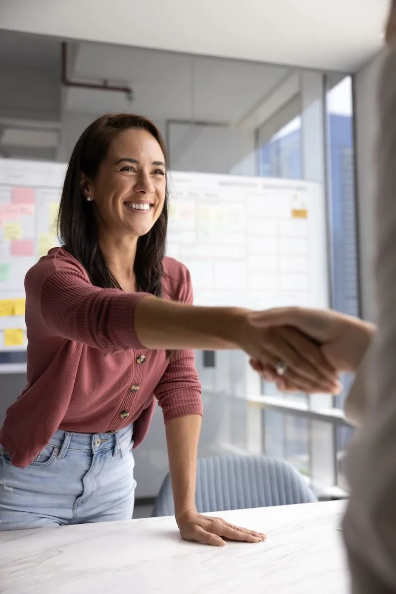business-owner Smiling professional shaking hands during a meeting in a modern office.